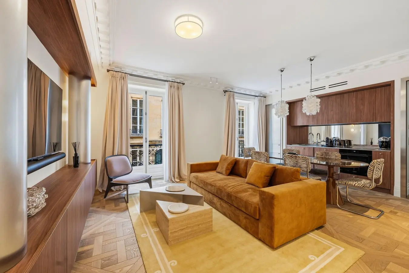 Living room of The Boissy 2, rue Boissy d'Anglas: herringbone parquet, velvet sofa and tall windows