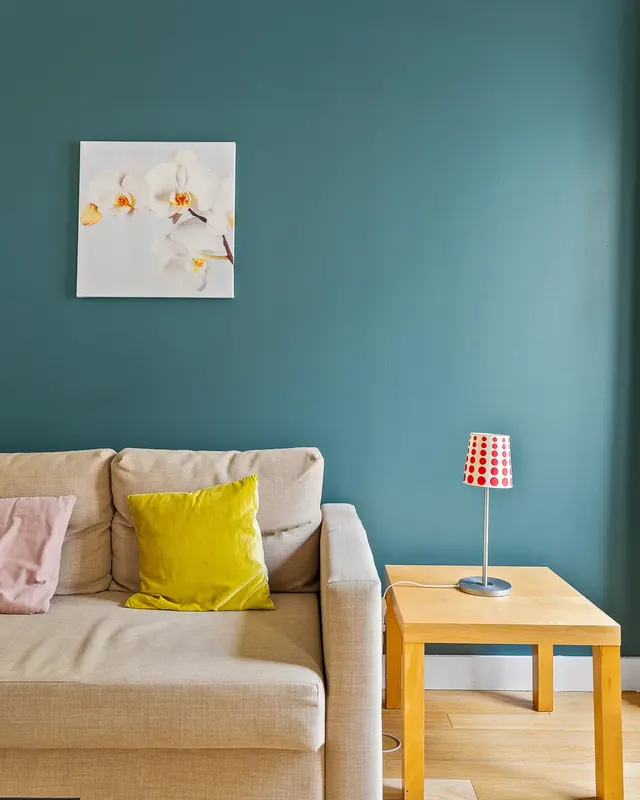 Teal wall and sofa at Pascal One